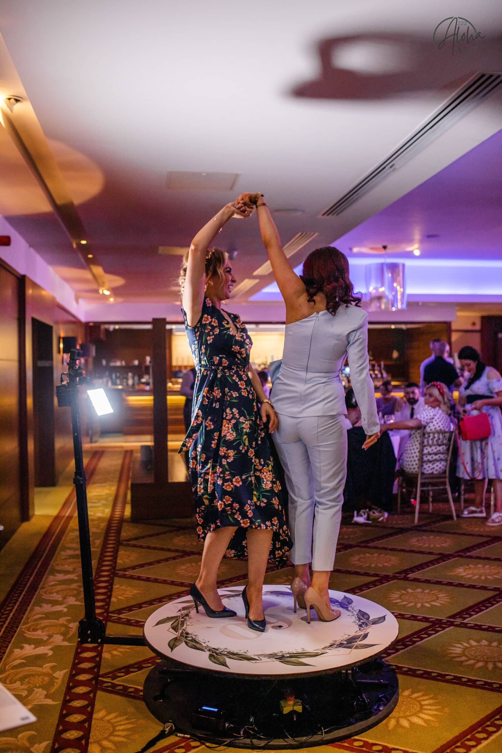 Two ladies dancing on 360 Dreambooth platform
