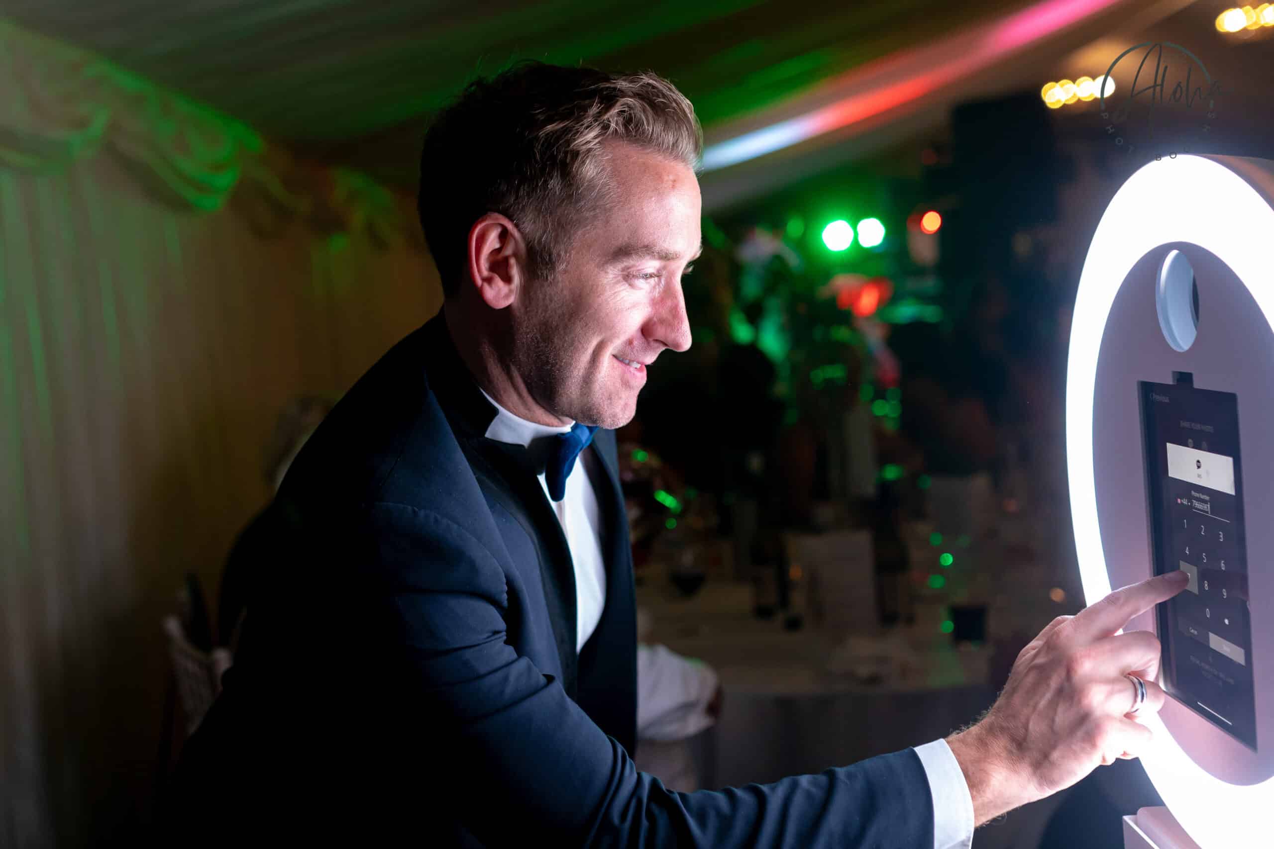A guest using the text feature on the Mobi Aura photo booth