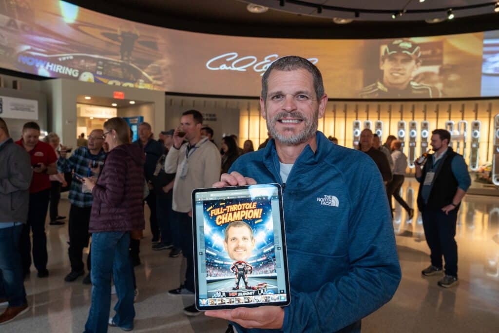 Guest holding a racing-themed AI photo booth portrait at NASCAR Hall of Fame in Charlotte, NC