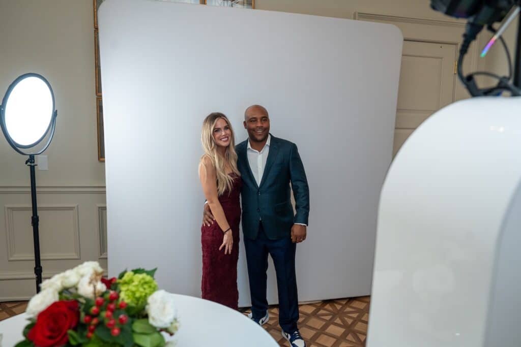 Couple posing at a glam photo booth during a nonprofit gala in Charlotte, NC