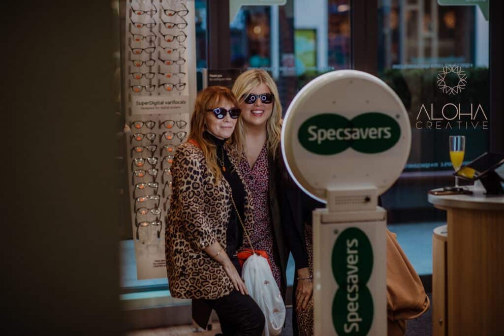 Guests trying on sunglasses at a branded photo booth activation in Charlotte, NC