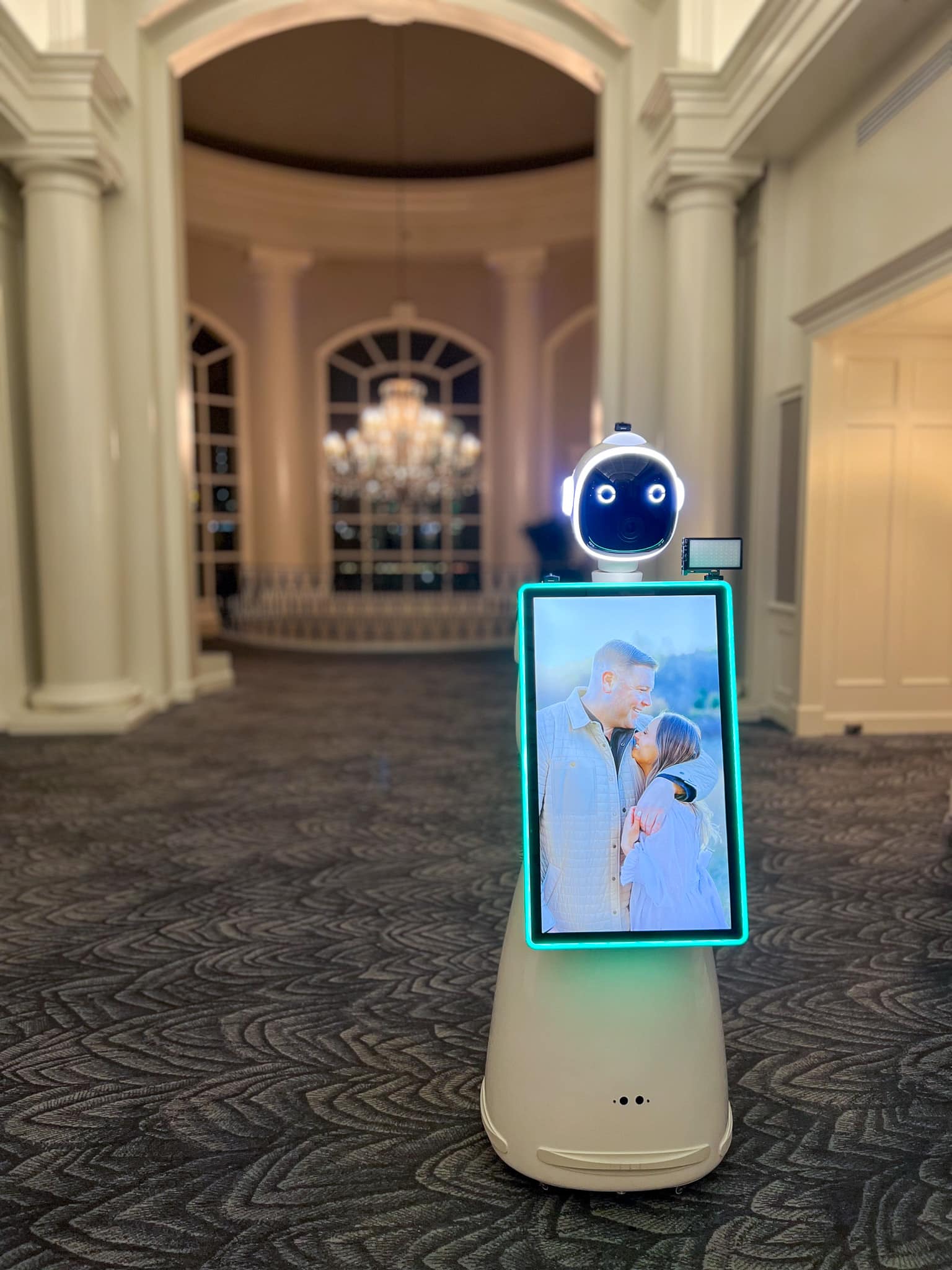 Rosie AI photo booth setup in an elegant Ballantyne wedding venue hallway with white columns