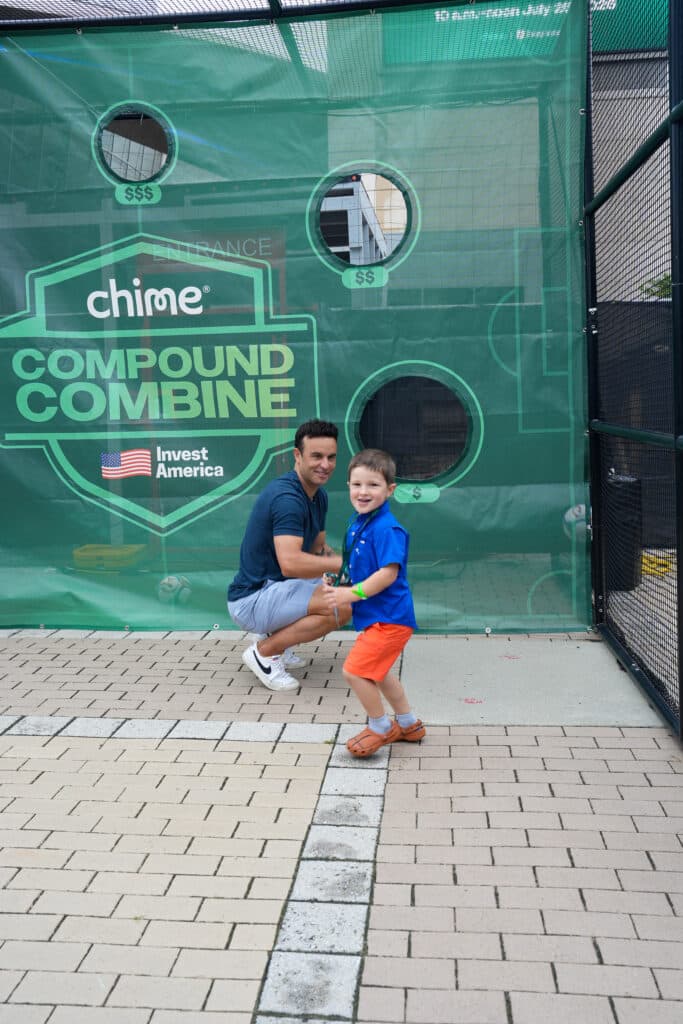 Guest interacting with a branded green wall installation at a Charlotte brand activation